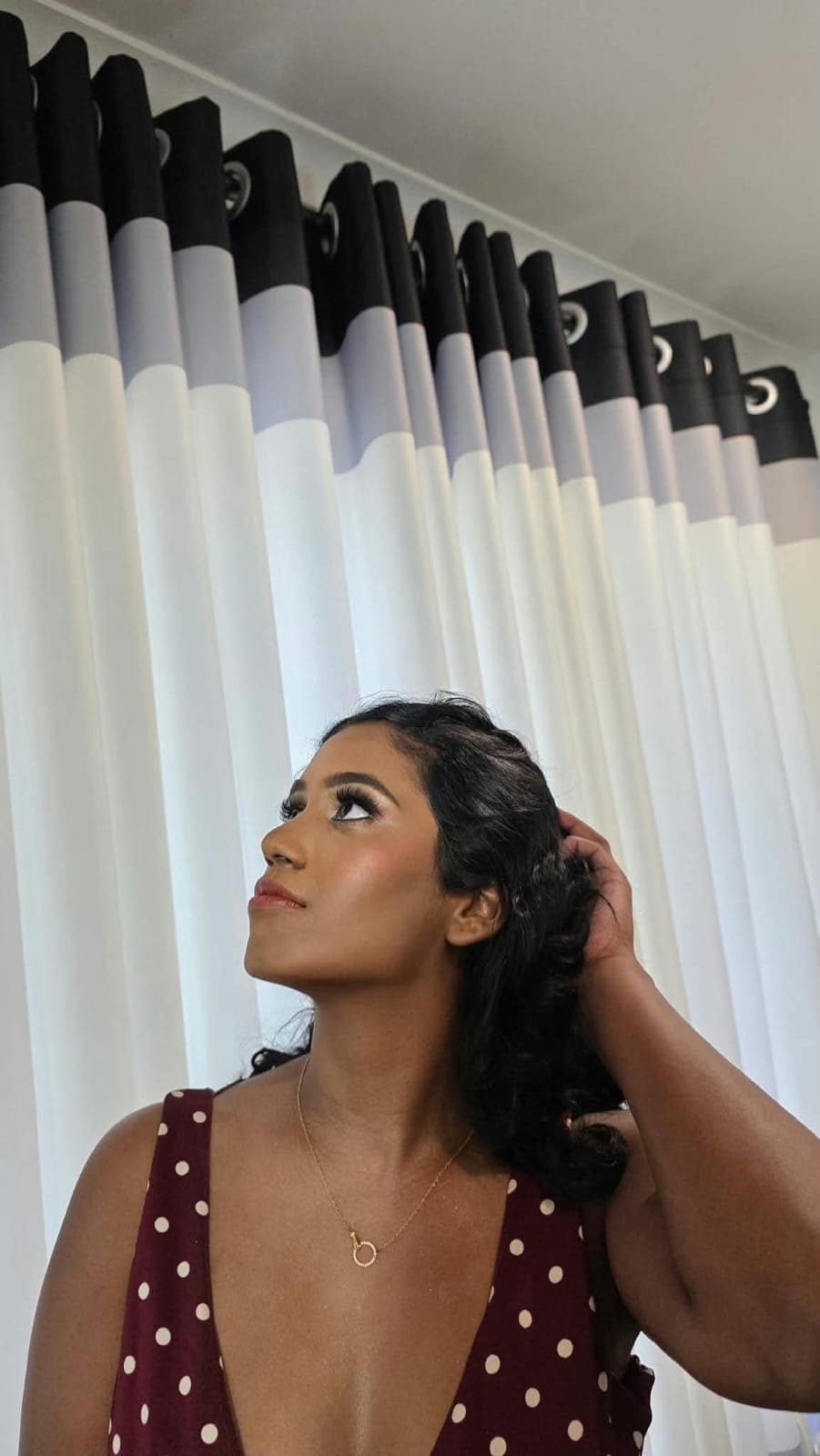 Profile view of special-occasion glam makeup with a sculpted brow and lash detail